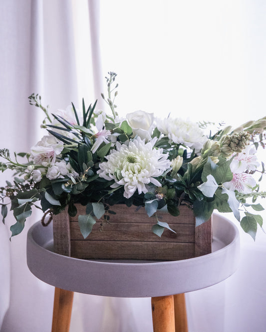whit flowers, white rose, white alstroemeria, white stock, white and green center piece, barn board box, eucalyptus, tuber rose, floral arrangement