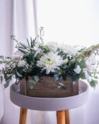 whit flowers, white rose, white alstroemeria, white stock, white and green center piece, barn board box, eucalyptus, tuber rose, floral arrangement 