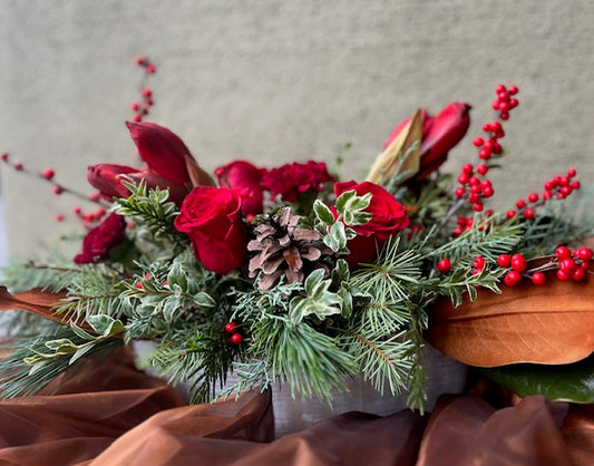 red amaryllis, red roses, red berries, evergreen, burgundy carnations, wooden container, pine cones, holiday flower arrangement, Christmas center piece