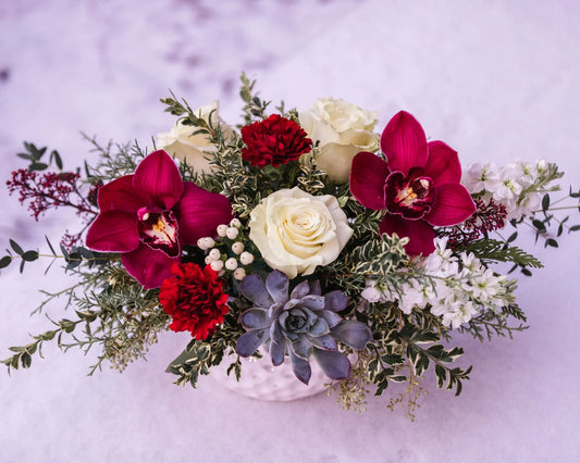 burgundy orchids, carnations, white roses, succulent, berries, evergreen arrangement