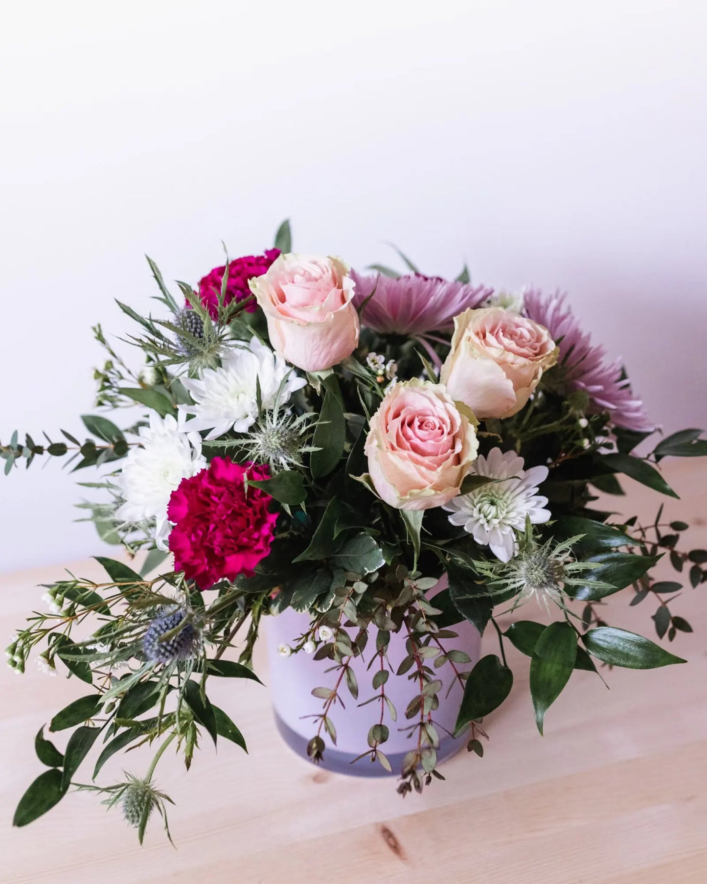 pink roses, pink carnations, thistl, daisies, greenery, arrangement, floral arrangement