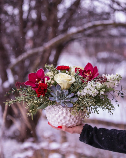 burgundy orchids, carnations, white roses, succulent, berries, evergreen arrangement